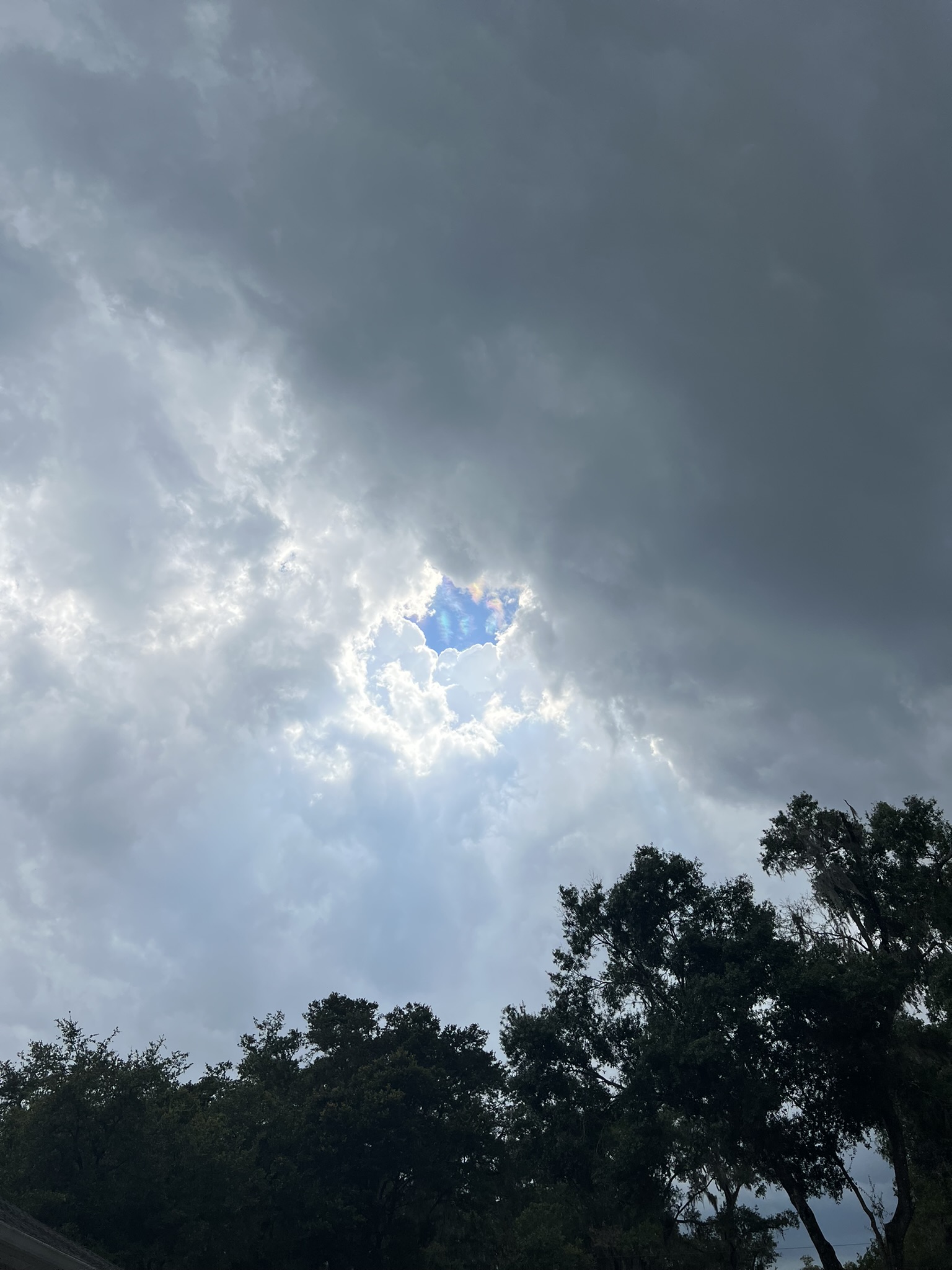 The sky is cloudy and a storm is coming from the east. In the center the blue sky struggles to be visible.